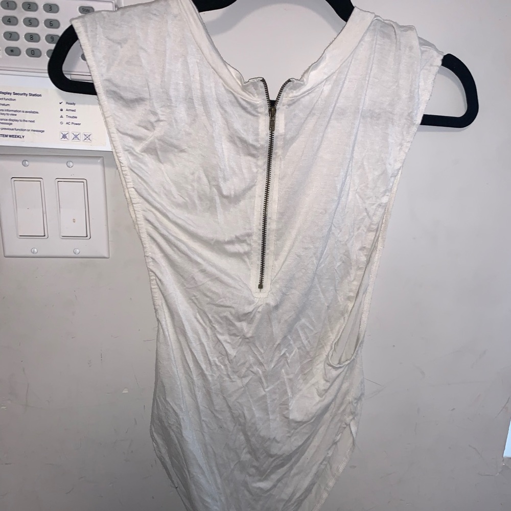 White bodysuit with snaps. Open sides. Zipper in front. Size L.
